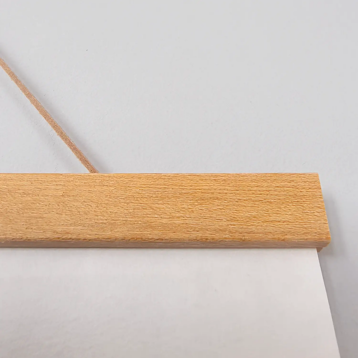 Handwritten Heart Sutra Chinese calligraphy hanging scroll with teak rods, displayed on a minimal white wall.