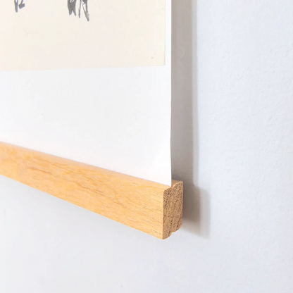 Handwritten Heart Sutra Chinese calligraphy hanging scroll with teak rods, displayed on a minimal white wall.