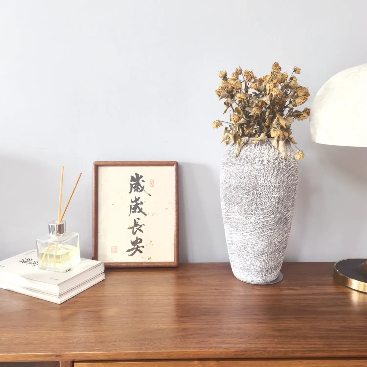 “岁岁长安” Chinese calligraphy artwork displayed in a calm contemporary living room with a solid ebony wood frame|FEIverse